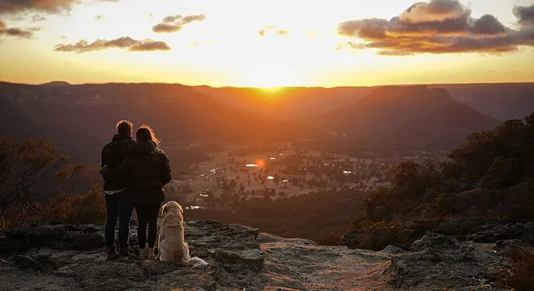 Couple enjoying panoramic Blue Mountains scenery at sunset