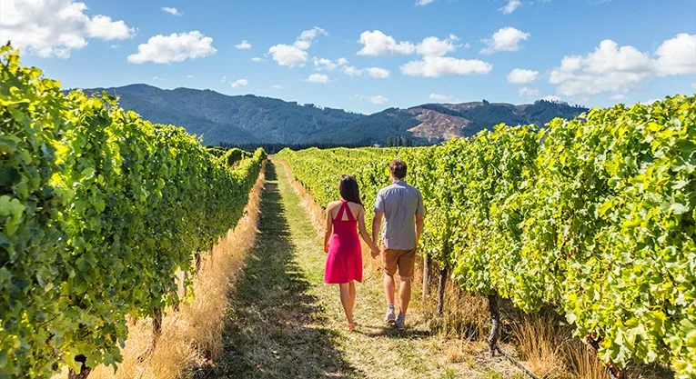 Couple walking through vineyards in the Hunter Valley wine region