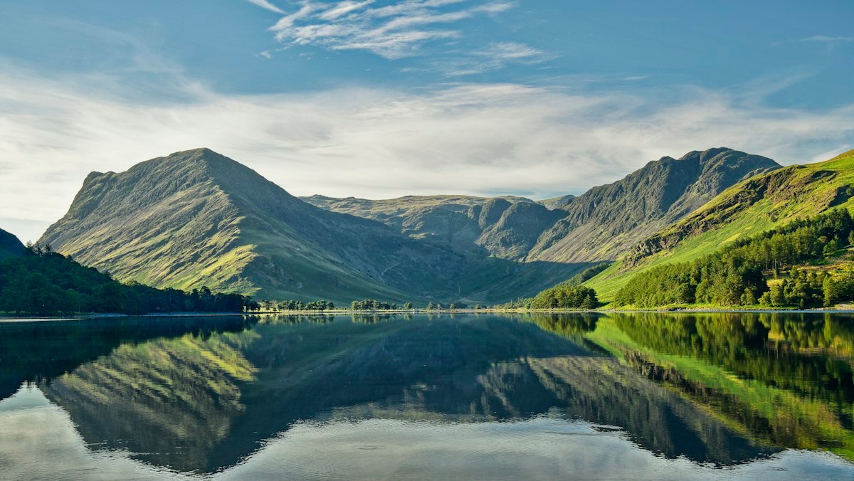 Fells reflected in the still water of Buttermere in the Lake District, an accessible UK countryside destination